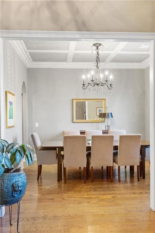 dining room featuring coffered ceiling, a notable chandelier, beamed ceiling, and light wood-type flooring