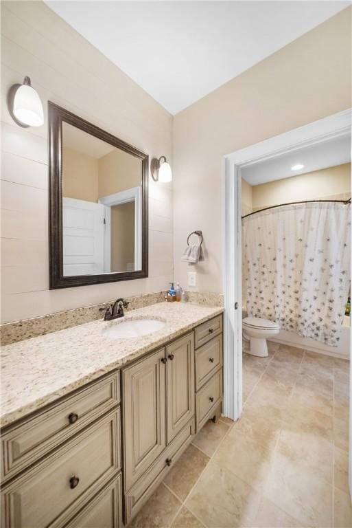 bathroom featuring a shower with curtain, vanity, toilet, and tile patterned flooring