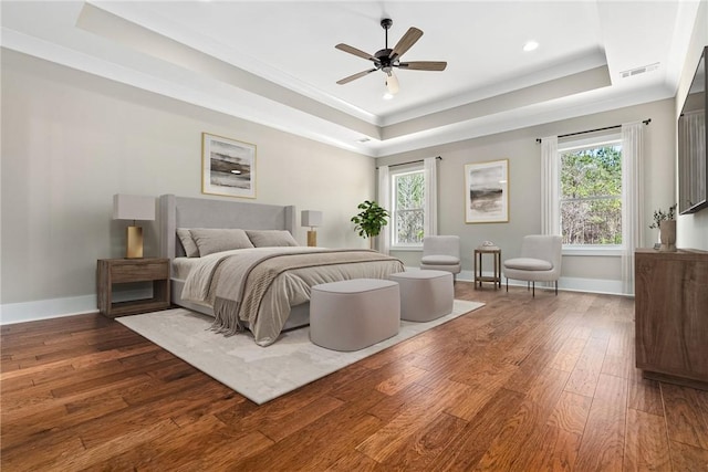 3667 Tiana Way, Opelika, AL 36801 - bedroom featuring a raised ceiling, hardwood / wood-style flooring, multiple windows, baseboards, and crown molding