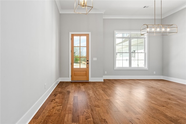 3667 Tiana Way, Opelika, AL 36801 - entrance foyer with a chandelier, crown molding, wood finished floors, healthy amount of natural light, and baseboards