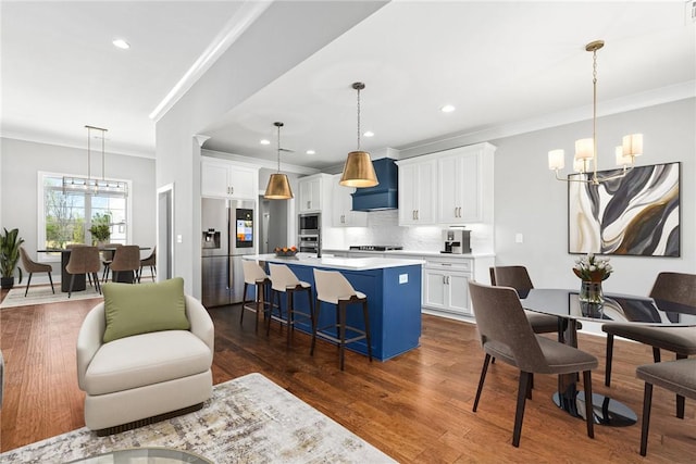 3667 Tiana Way, Opelika, AL 36801 - kitchen featuring a chandelier, stainless steel appliances, a kitchen bar, crown molding, and white cabinetry