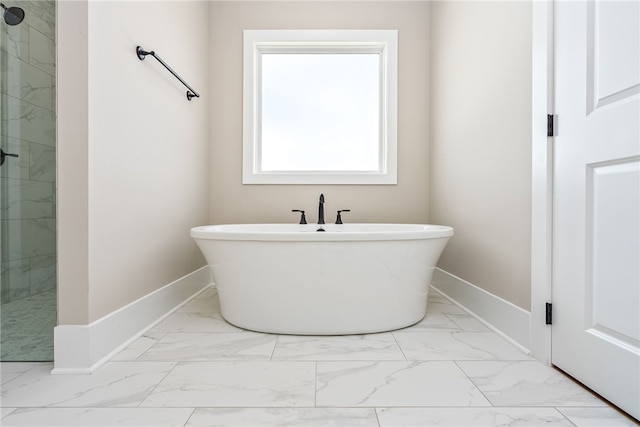 3667 Tiana Way, Opelika, AL 36801 - full bathroom with marble look tiles, a soaking tub, and baseboards