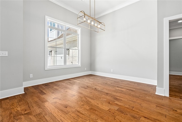 3667 Tiana Way, Opelika, AL 36801 - unfurnished dining area with a chandelier, crown molding, healthy amount of natural light, and wood finished floors