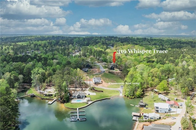 aerial overview of property's location featuring a heavily wooded area and a nearby body of water