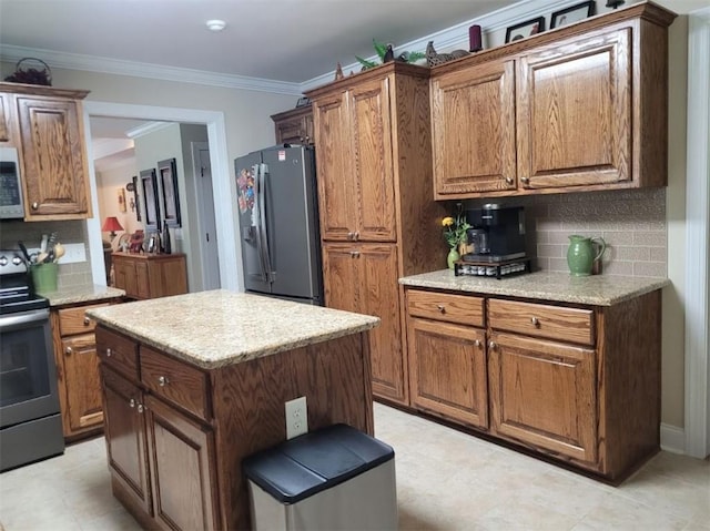 212 Melody Ln, Valley, AL 36854 - kitchen with stainless steel fridge, electric range, tasteful backsplash, crown molding, and brown cabinetry