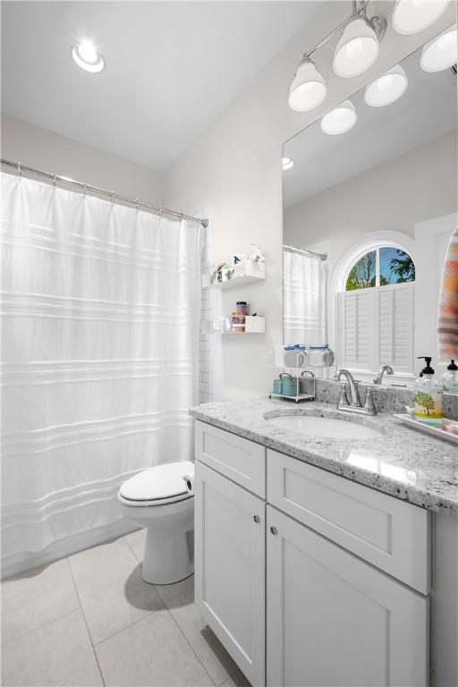1321 Falls Crest Dr, Auburn, AL 36830 - full bathroom with tile patterned flooring, curtained shower, vanity, and toilet