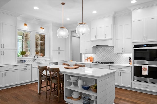 1321 Falls Crest Dr, Auburn, AL 36830 - kitchen with open shelves, ornamental molding, light countertops, stainless steel appliances, and a kitchen island