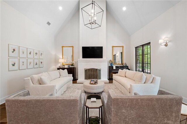 1321 Falls Crest Dr, Auburn, AL 36830 - living area featuring high vaulted ceiling, visible vents, a fireplace with raised hearth, a chandelier, and baseboards