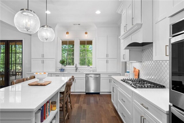 1321 Falls Crest Dr, Auburn, AL 36830 - kitchen with crown molding, white cabinets, appliances with stainless steel finishes, light countertops, and a sink