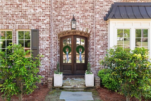 1321 Falls Crest Dr, Auburn, AL 36830 - view of exterior entry with brick siding, french doors, metal roof, and a standing seam roof