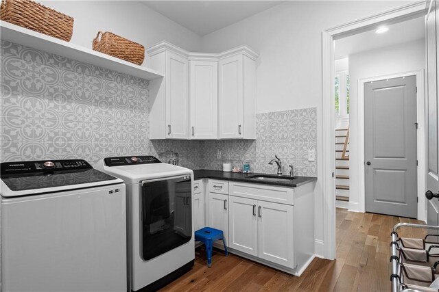 1321 Falls Crest Dr, Auburn, AL 36830 - laundry area with a sink, cabinet space, washer and dryer, and wood finished floors