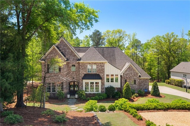 1321 Falls Crest Dr, Auburn, AL 36830 - view of front of property featuring board and batten siding, a front yard, brick siding, and driveway