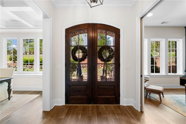 1321 Falls Crest Dr, Auburn, AL 36830 - foyer entrance featuring crown molding, arched walkways, wood finished floors, and a healthy amount of sunlight
