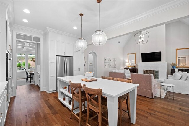 1321 Falls Crest Dr, Auburn, AL 36830 - dining room featuring crown molding, dark wood-style flooring, and arched walkways