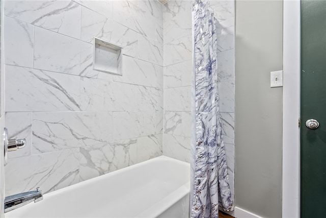 bathroom with shower / bath combo with shower curtain