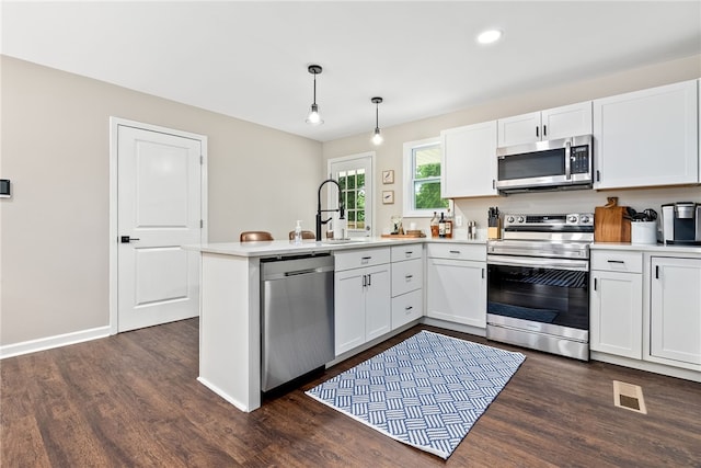 573 Hudson Ter, Auburn, AL 36830 - kitchen with appliances with stainless steel finishes, a peninsula, dark wood-style floors, white cabinetry, and recessed lighting