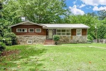 ranch-style house featuring a front lawn