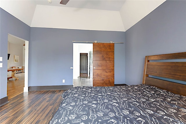 bedroom with baseboards, high vaulted ceiling, and wood finished floors