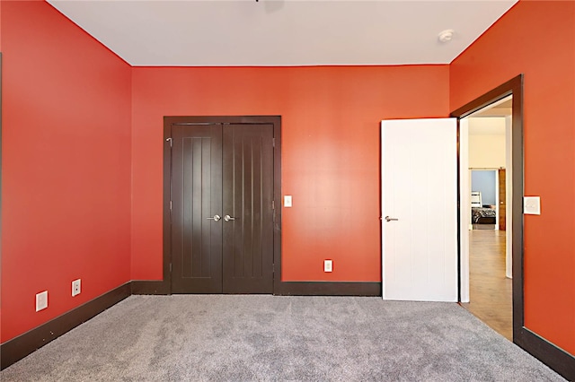 unfurnished bedroom with baseboards and carpet flooring