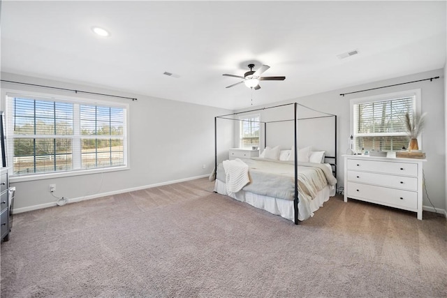 unfurnished bedroom with multiple windows, ceiling fan, and carpet flooring