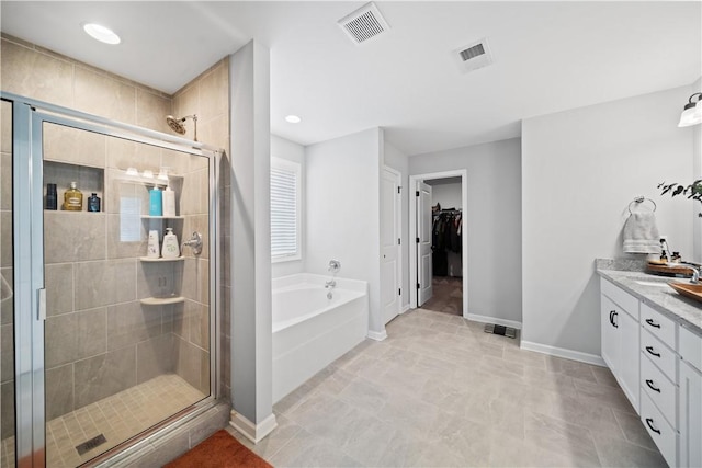 bathroom with vanity and separate shower and tub