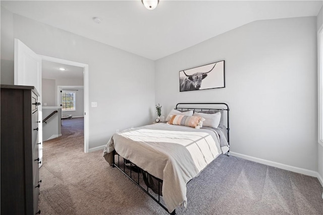 bedroom with vaulted ceiling and light carpet