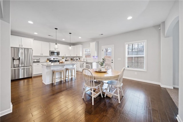 dining area featuring dark hardwood / wood-style floors and sink