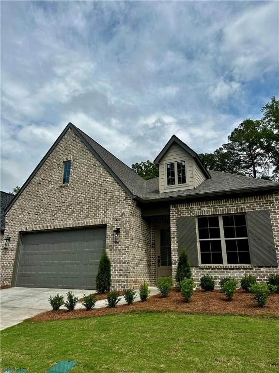 465 Windsor Dr, Opelika, AL 36801 - view of front of home featuring brick siding, a front yard, and driveway