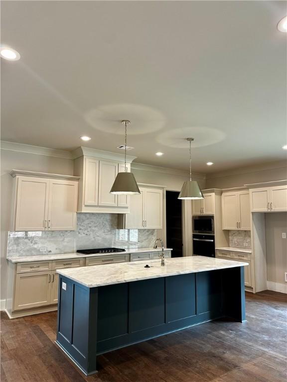 465 Windsor Dr, Opelika, AL 36801 - kitchen featuring cooktop, stainless steel microwave, oven, backsplash, and white cabinetry