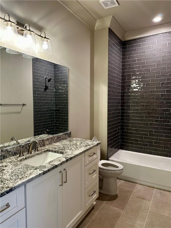 465 Windsor Dr, Opelika, AL 36801 - full bathroom featuring tile patterned flooring, toilet, vanity, and tiled shower / bath combo