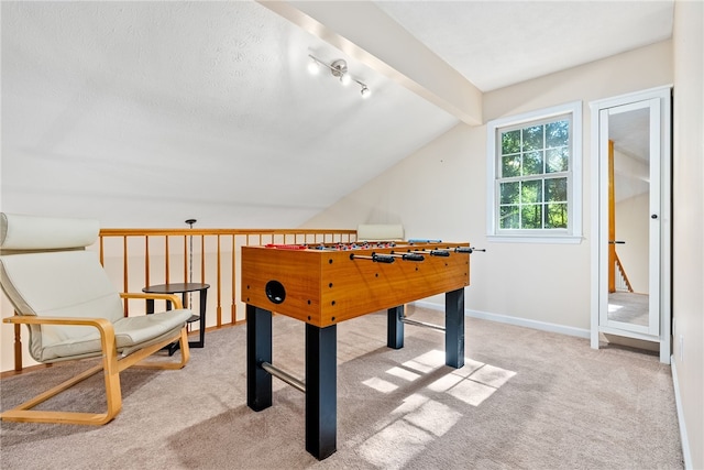 rec room with vaulted ceiling with beams and light colored carpet