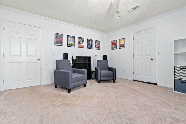 living area with light colored carpet, a textured ceiling, and ornamental molding