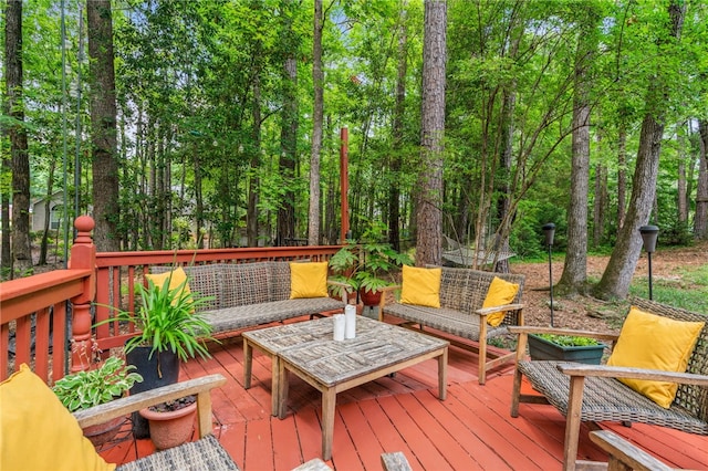 wooden terrace with an outdoor living space