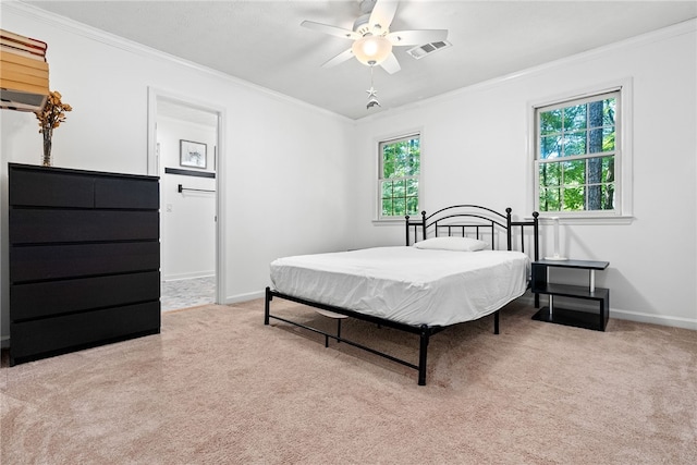 carpeted bedroom with ceiling fan and crown molding