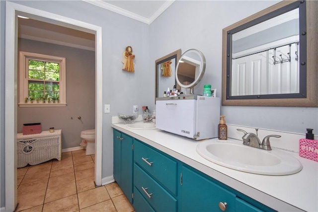 bathroom with tile patterned floors, toilet, vanity, and ornamental molding