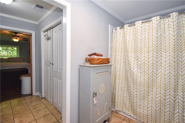 bathroom with tile patterned flooring, ceiling fan, and ornamental molding