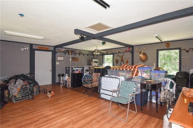 living room with ceiling fan, hardwood / wood-style floors, and a healthy amount of sunlight