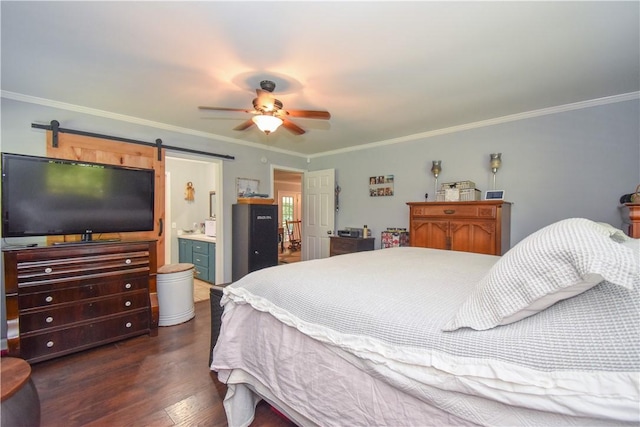 bedroom with dark wood-type flooring, ensuite bathroom, ceiling fan, a barn door, and ornamental molding