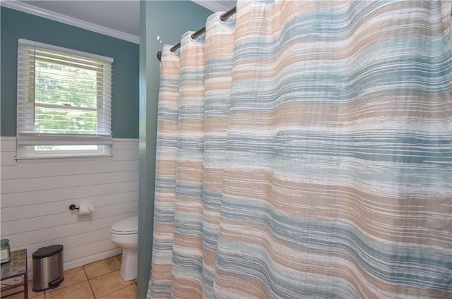 bathroom featuring tile patterned floors, toilet, and ornamental molding