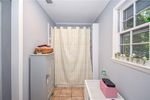 bathroom featuring tile patterned flooring, plenty of natural light, and crown molding