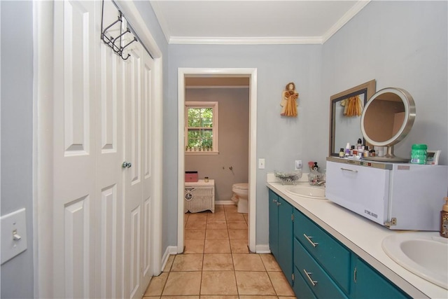 bathroom with tile patterned flooring, vanity, toilet, and crown molding