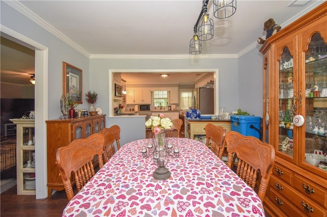 dining room with ornamental molding and dark wood-type flooring