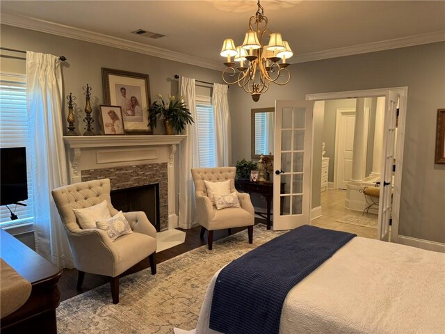 6207 County Road 222, Five Points, AL 36855 - bedroom featuring a chandelier, crown molding, a stone fireplace, and baseboards