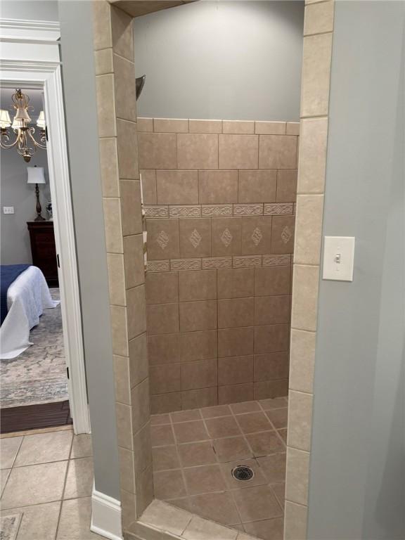 6207 County Road 222, Five Points, AL 36855 - full bathroom featuring a tile shower, tile patterned flooring, a chandelier, and connected bathroom