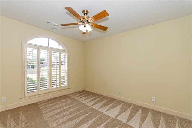 carpeted empty room featuring ceiling fan