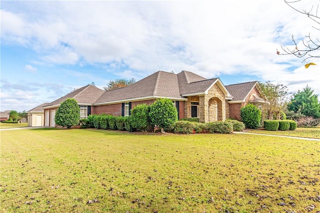 view of front of home featuring a front yard and a garage