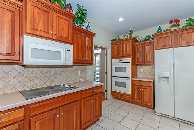 kitchen with white appliances, decorative backsplash, and light tile patterned floors