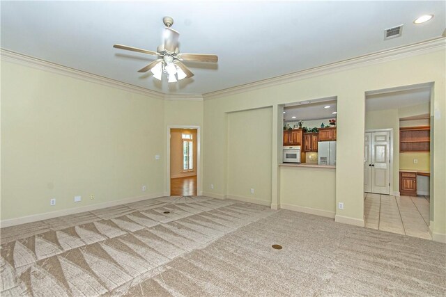 interior space with ceiling fan and crown molding