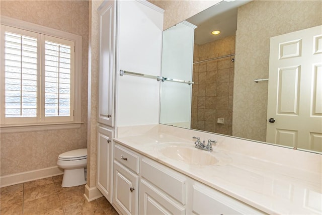 bathroom featuring a healthy amount of sunlight, vanity, tile patterned floors, and toilet