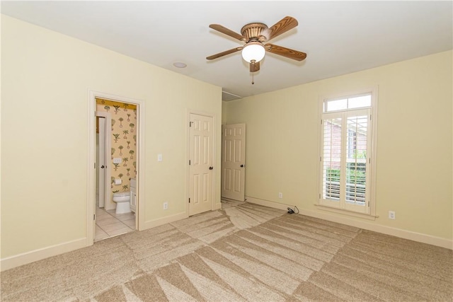 carpeted empty room featuring ceiling fan